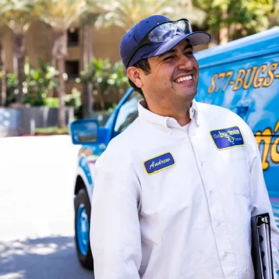bugman exterminator next to a truck