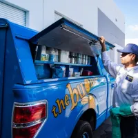 the bugman exterminator standing by the truck
